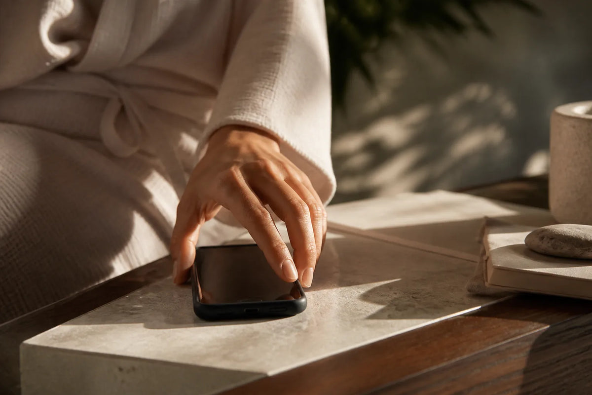 Nero 210X - binnensauna voor 4-5 personen in een scène van mentale rust met een telefoon met het scherm naar beneden op tafel